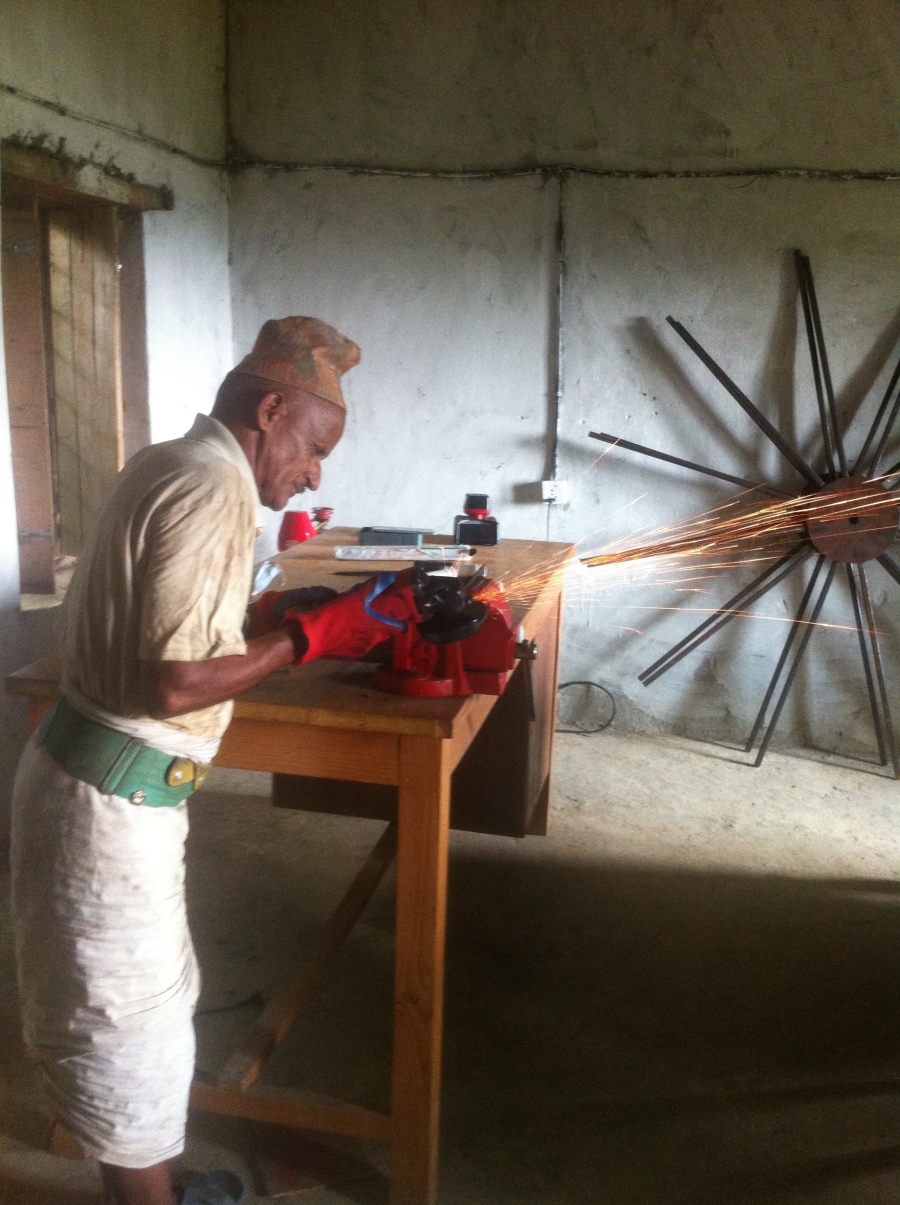 A local farmer working on technology and better farming practices in rural Nepa